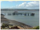 MUMBLES PIER. The picture was taken from Mumbles Lighthouse, in the background are the hills of Swansea and Port Talbot